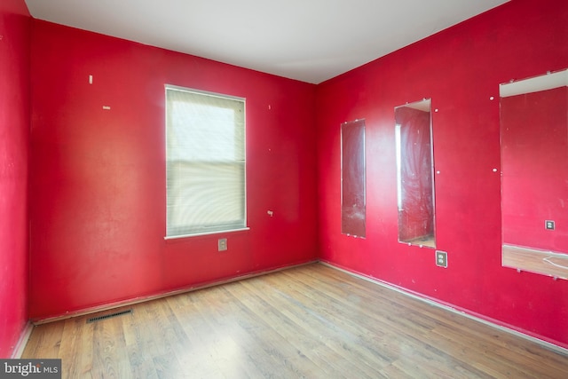 spare room with hardwood / wood-style floors