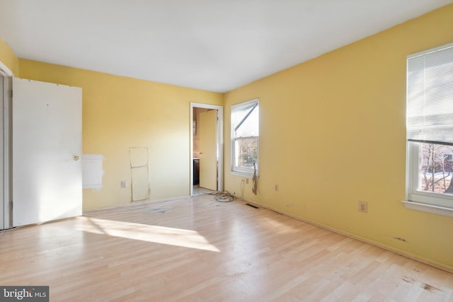 unfurnished room with light wood-type flooring