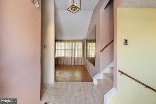 foyer featuring lofted ceiling and light wood-type flooring