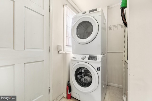 laundry area with stacked washer and dryer