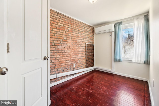 empty room featuring brick wall, dark hardwood / wood-style floors, and a wall unit AC