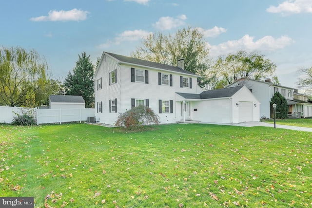 colonial house with a garage, a front yard, and central air condition unit