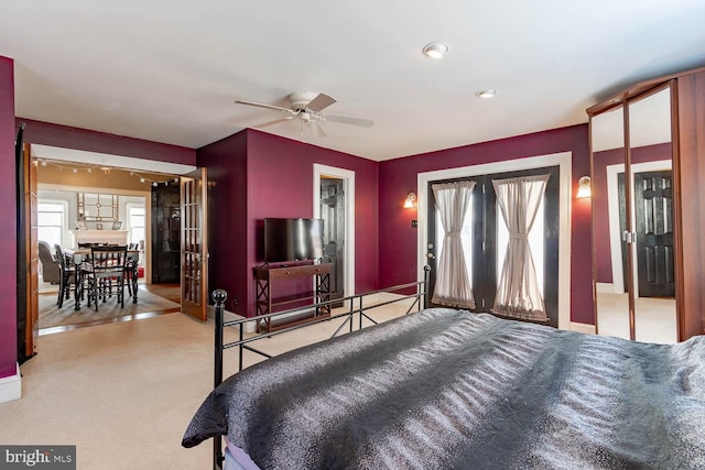 bedroom with ceiling fan and light carpet