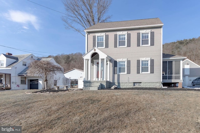 view of front of property with a front lawn and a sunroom