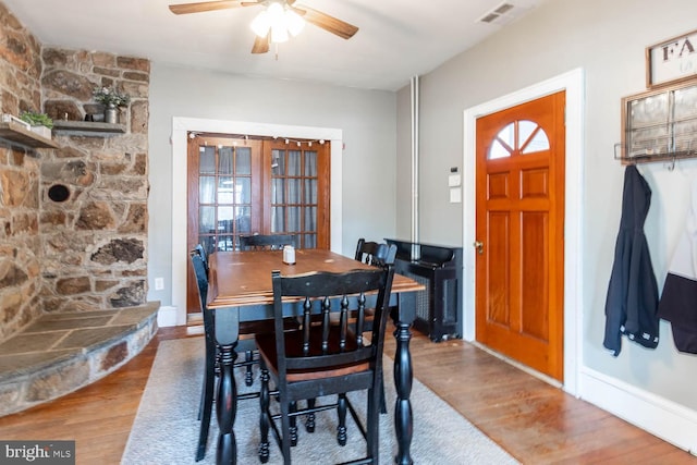 dining space featuring hardwood / wood-style flooring and ceiling fan