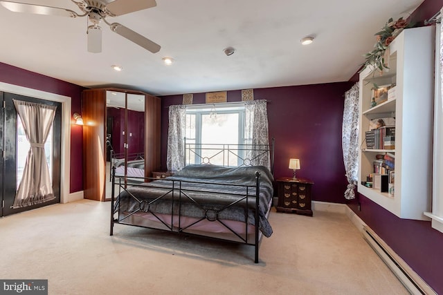 carpeted bedroom featuring ceiling fan and baseboard heating