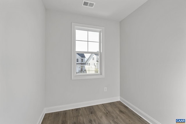 spare room with dark hardwood / wood-style flooring