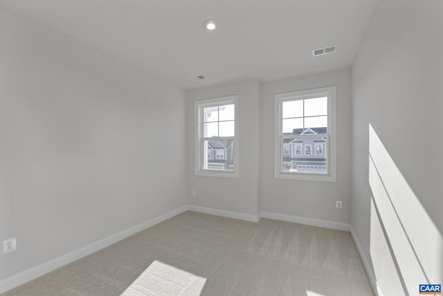 unfurnished room featuring light colored carpet