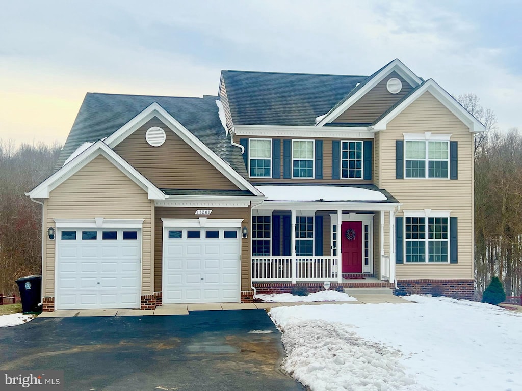 view of front facade with a garage and a porch