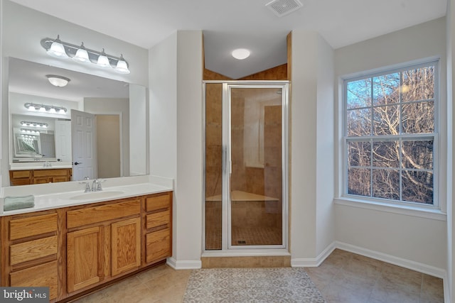 bathroom featuring vanity, tile patterned flooring, and a shower with door