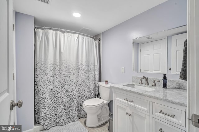 bathroom with walk in shower, vanity, and toilet