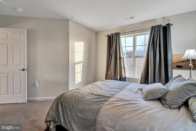 carpeted bedroom with lofted ceiling