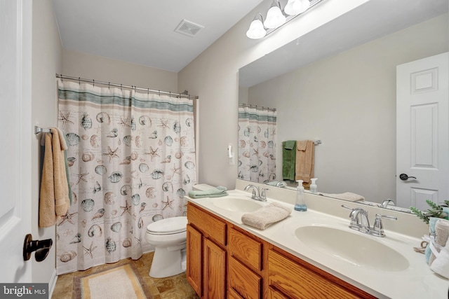 bathroom featuring vanity, curtained shower, and toilet