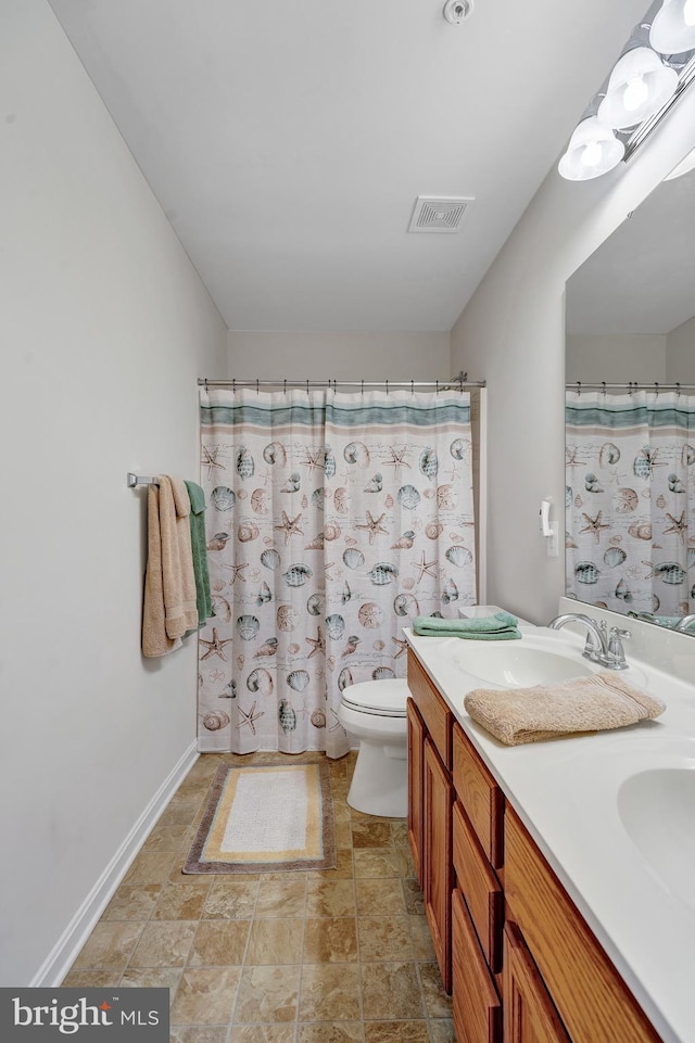 bathroom featuring a shower with curtain, vanity, and toilet