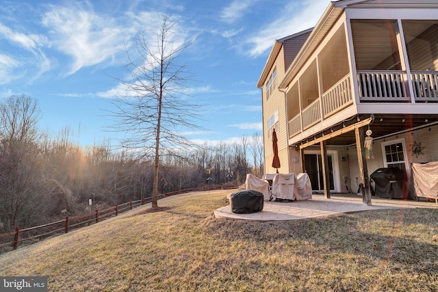 view of yard with a sunroom and a patio