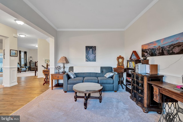 living room with crown molding and hardwood / wood-style flooring