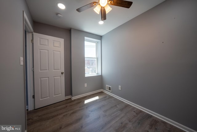 unfurnished bedroom featuring dark wood-type flooring and ceiling fan