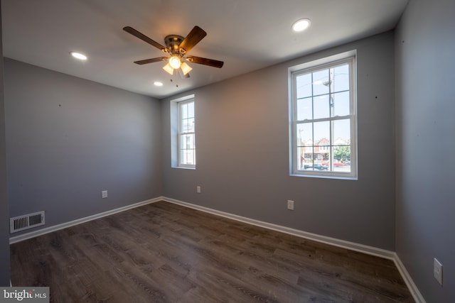 unfurnished room with dark wood-type flooring and ceiling fan