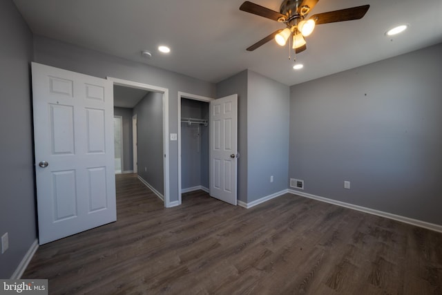 unfurnished bedroom with ceiling fan, dark hardwood / wood-style flooring, and a closet