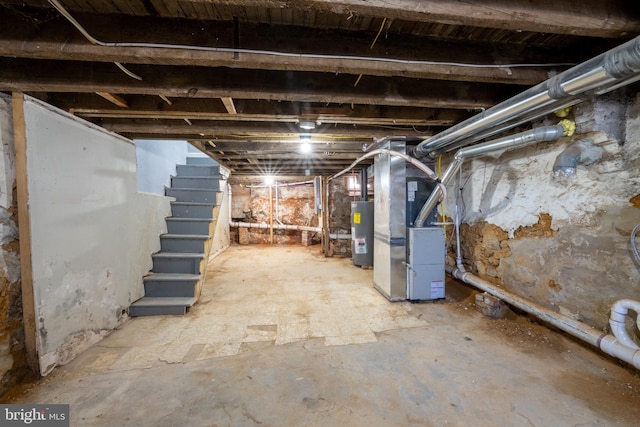 basement featuring heating unit and water heater