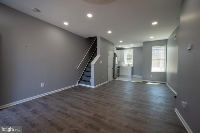 unfurnished living room featuring dark wood-type flooring