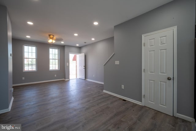 interior space featuring ceiling fan and dark hardwood / wood-style flooring