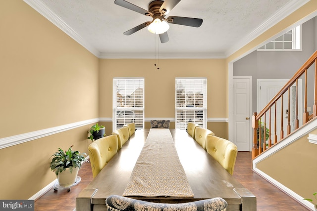 dining room with hardwood / wood-style flooring, ceiling fan, ornamental molding, and a textured ceiling