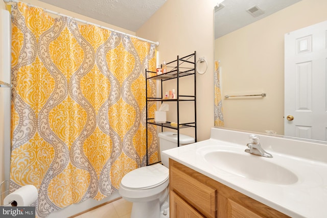 bathroom with tile patterned flooring, vanity, a textured ceiling, a shower with curtain, and toilet