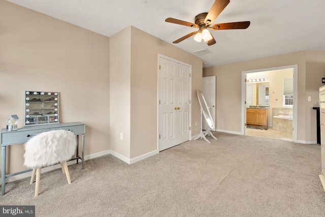 office featuring light carpet and ceiling fan