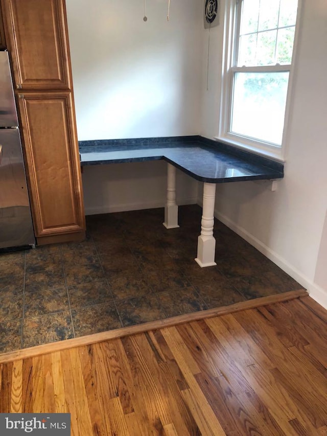 unfurnished dining area with dark hardwood / wood-style floors