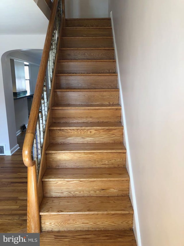 stairway featuring wood-type flooring