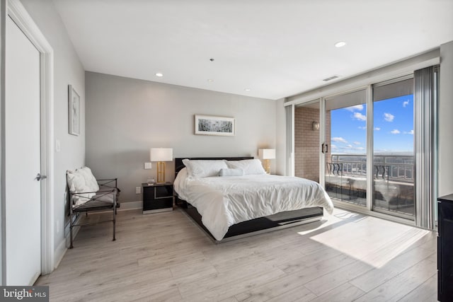 bedroom with access to outside and light hardwood / wood-style flooring