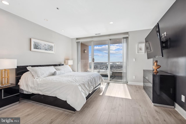 bedroom featuring access to exterior and light wood-type flooring