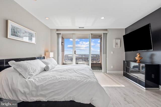 bedroom with access to outside and light wood-type flooring