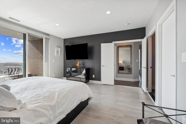 bedroom with access to exterior and light wood-type flooring