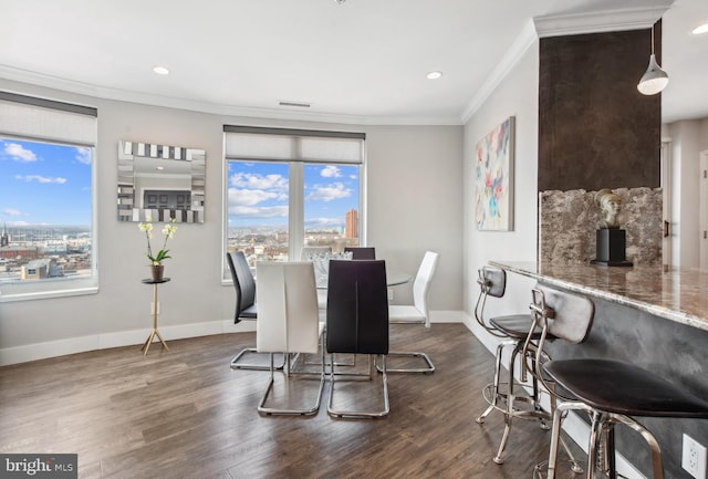 dining room with crown molding and dark wood-type flooring