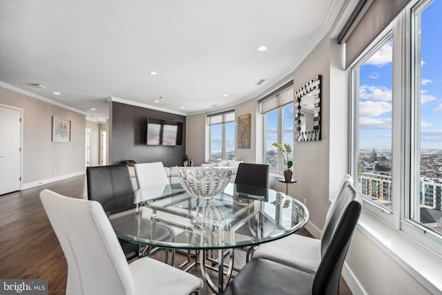 dining space featuring ornamental molding and dark hardwood / wood-style floors