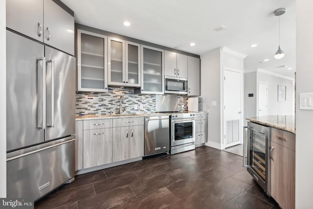 kitchen with sink, pendant lighting, stainless steel appliances, beverage cooler, and light stone countertops