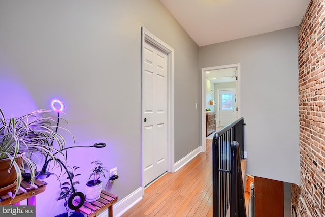 corridor with light hardwood / wood-style floors