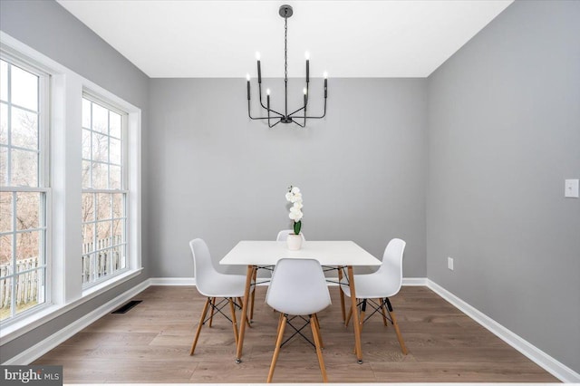 dining area featuring a chandelier and hardwood / wood-style floors