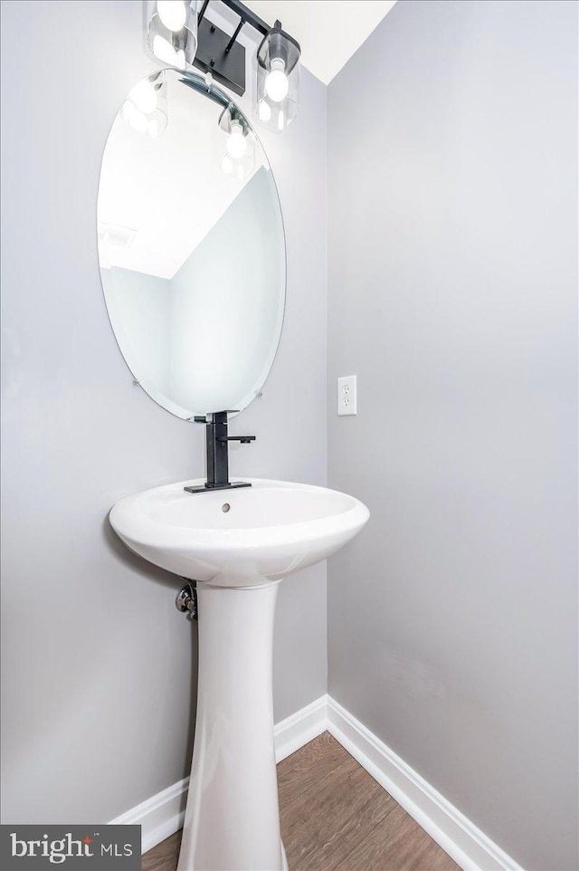 bathroom with hardwood / wood-style flooring