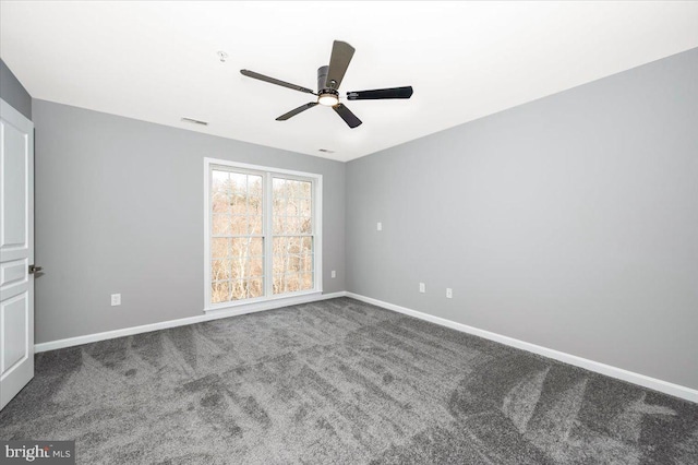 carpeted spare room featuring ceiling fan