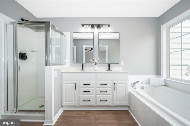 bathroom featuring plenty of natural light, shower with separate bathtub, wood-type flooring, and vanity