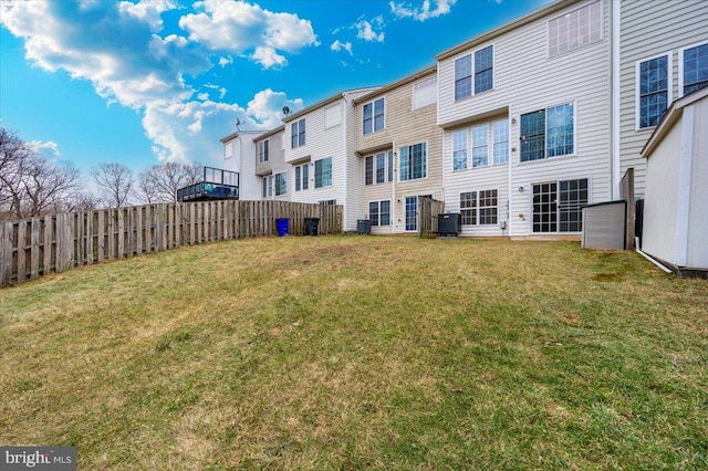 exterior space with a lawn and central air condition unit