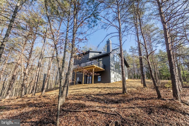 back of property featuring a wooden deck