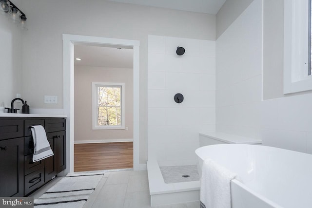 bathroom featuring vanity and shower with separate bathtub