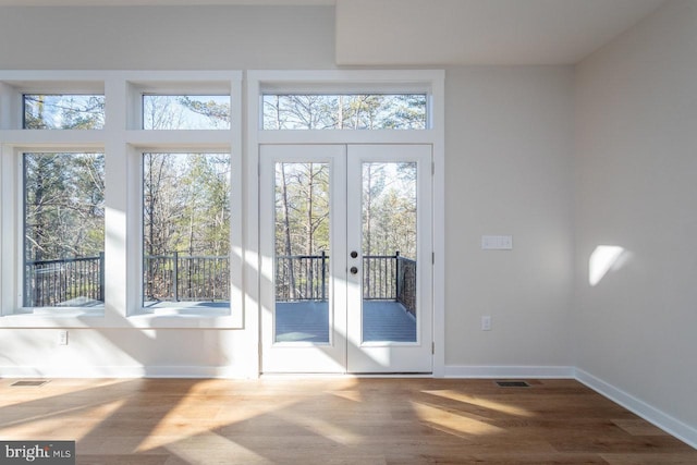 entryway featuring hardwood / wood-style flooring, french doors, and a wealth of natural light