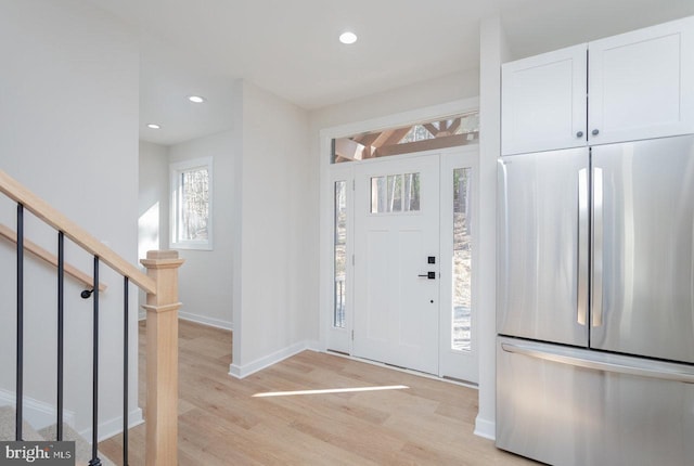 entryway with light hardwood / wood-style floors