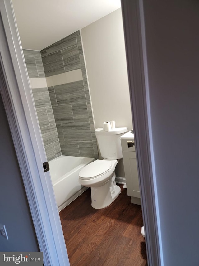 bathroom with vanity, hardwood / wood-style flooring, and toilet