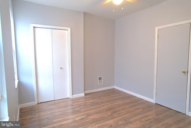 unfurnished bedroom featuring hardwood / wood-style floors and a closet